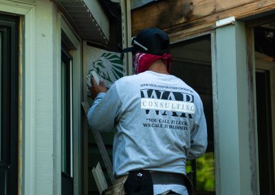 employee replacing siding
