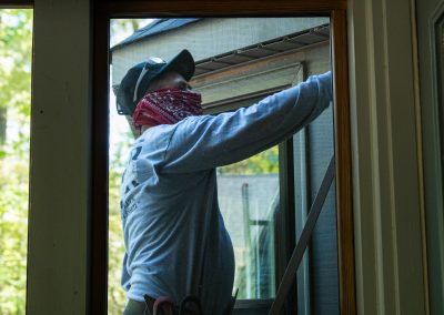 employee replacing siding