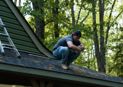 employee on roof taking notes