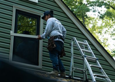 employee replacing window treatment