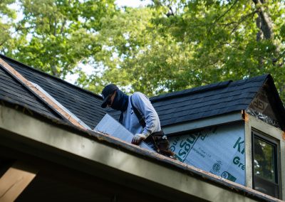 employee replacing roof