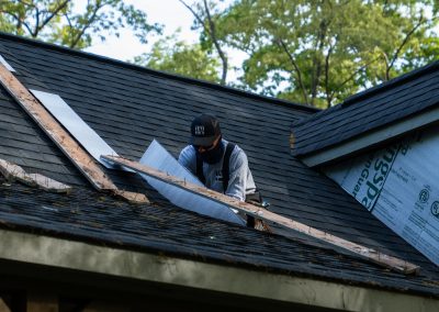 employee replacing roof